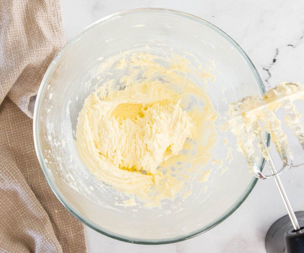 The butter and sugar beaten together in a bowl.