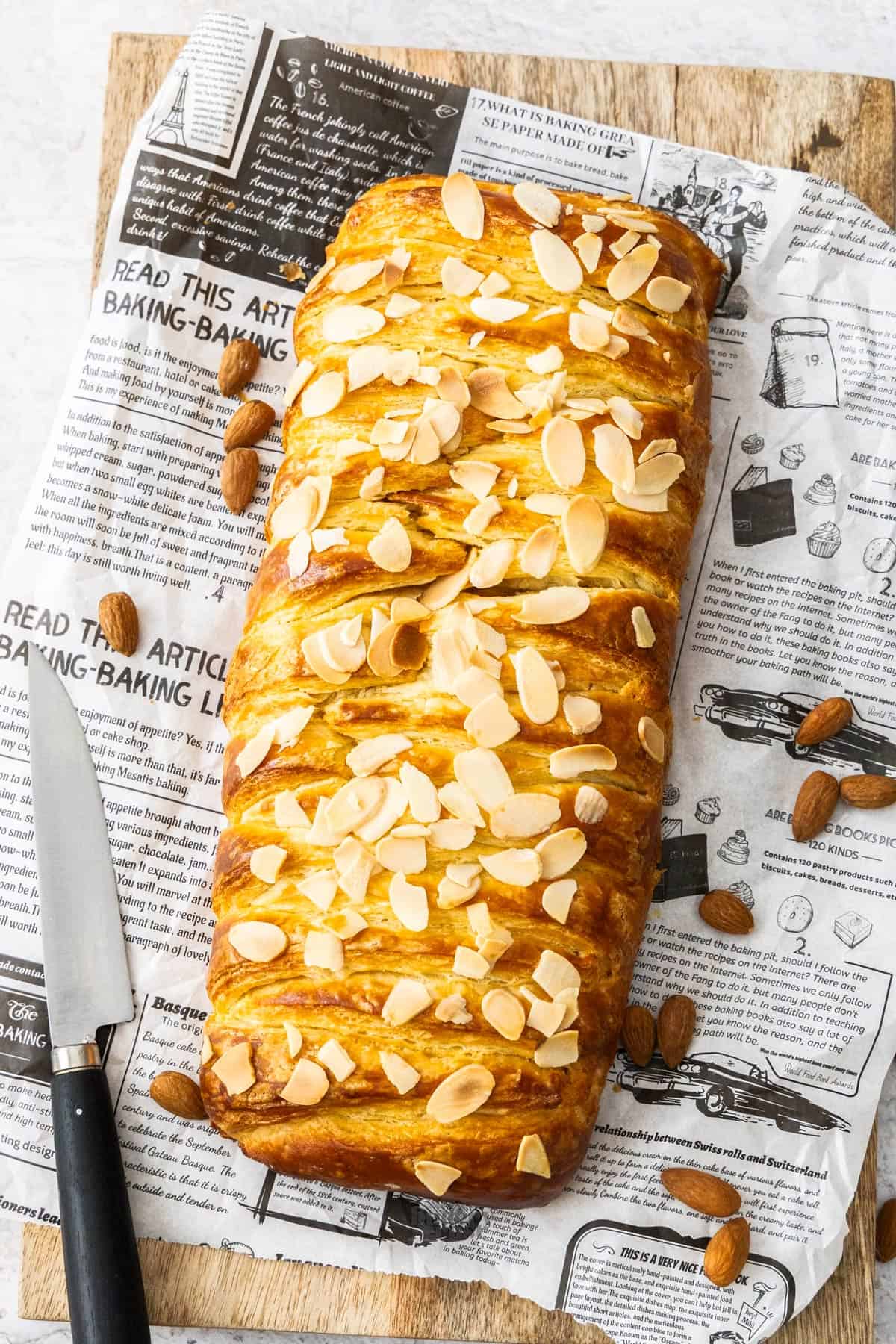 The baked almond Danish braid on a wooden board.