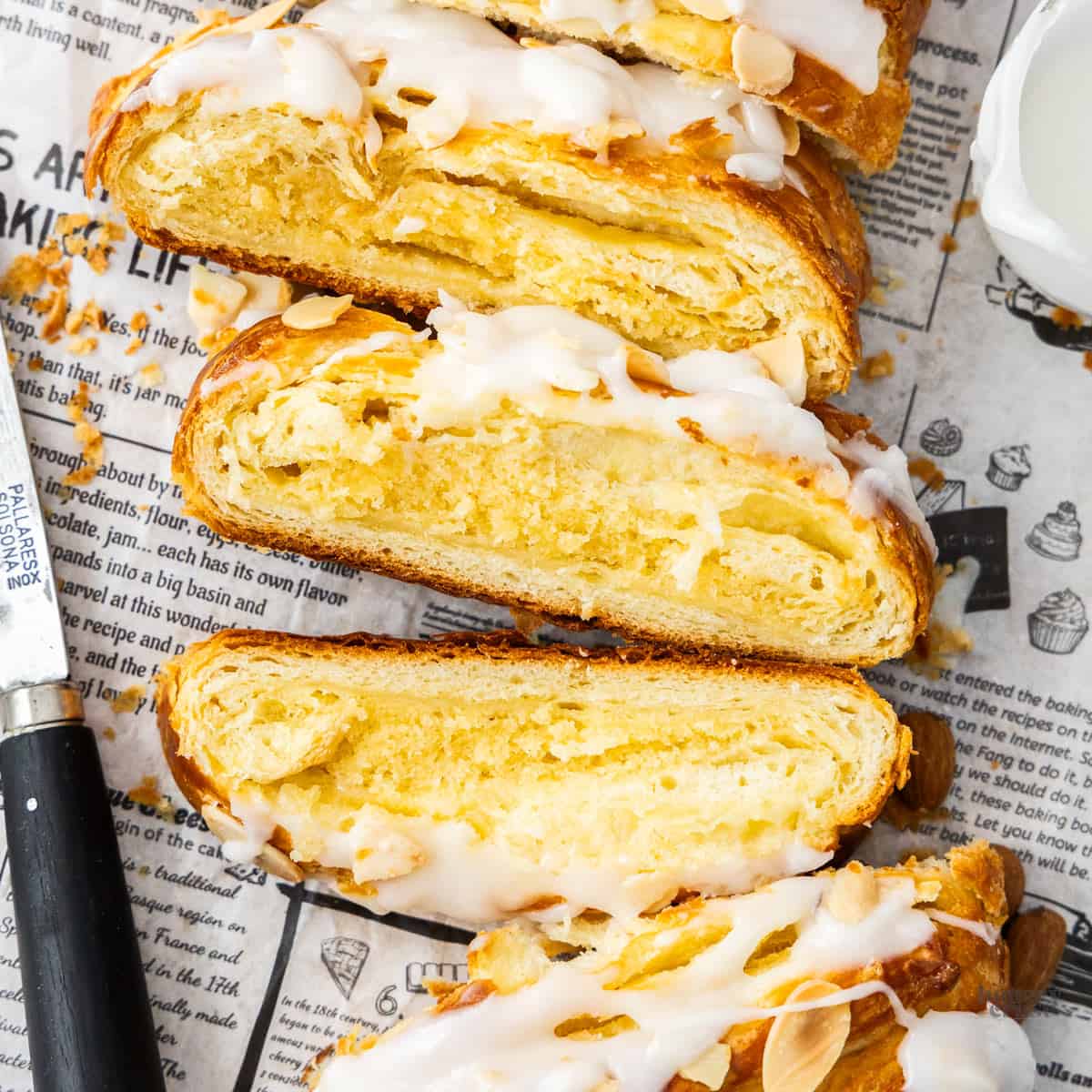 Top down view of an almond Danish braid cut into slices.