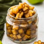 Closeup of a jar overflowing with apple compote.