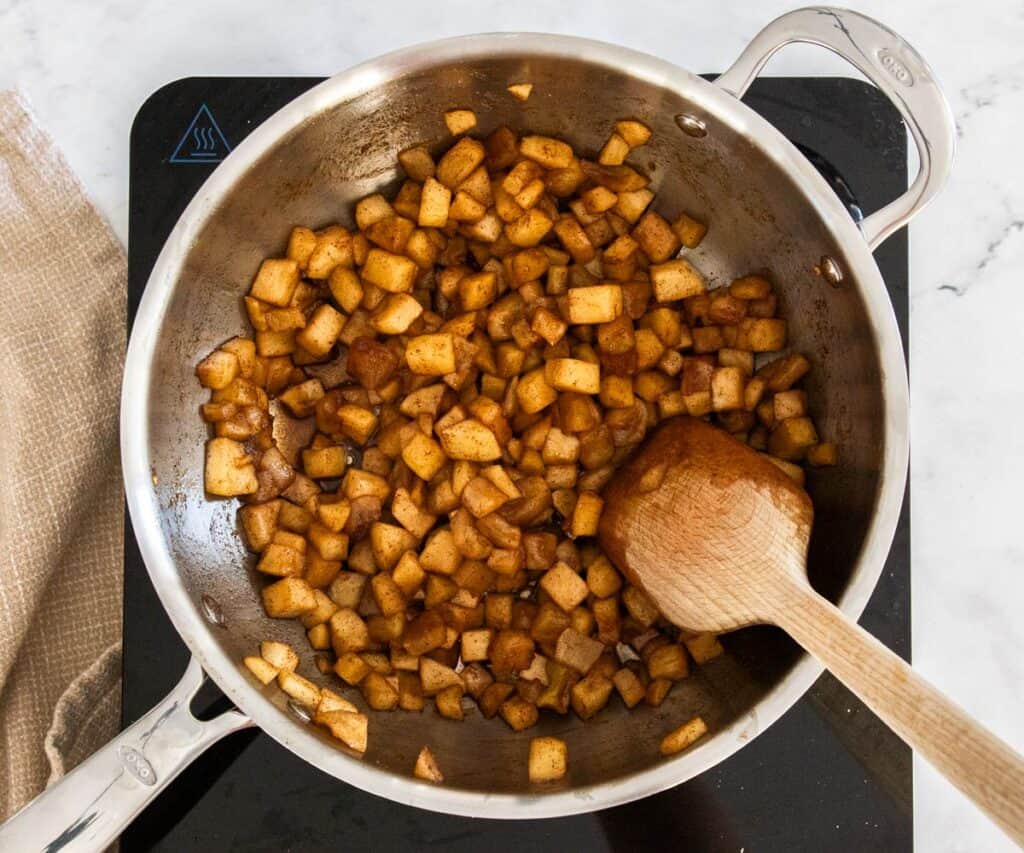 Apple compote cooking in a saucepan.