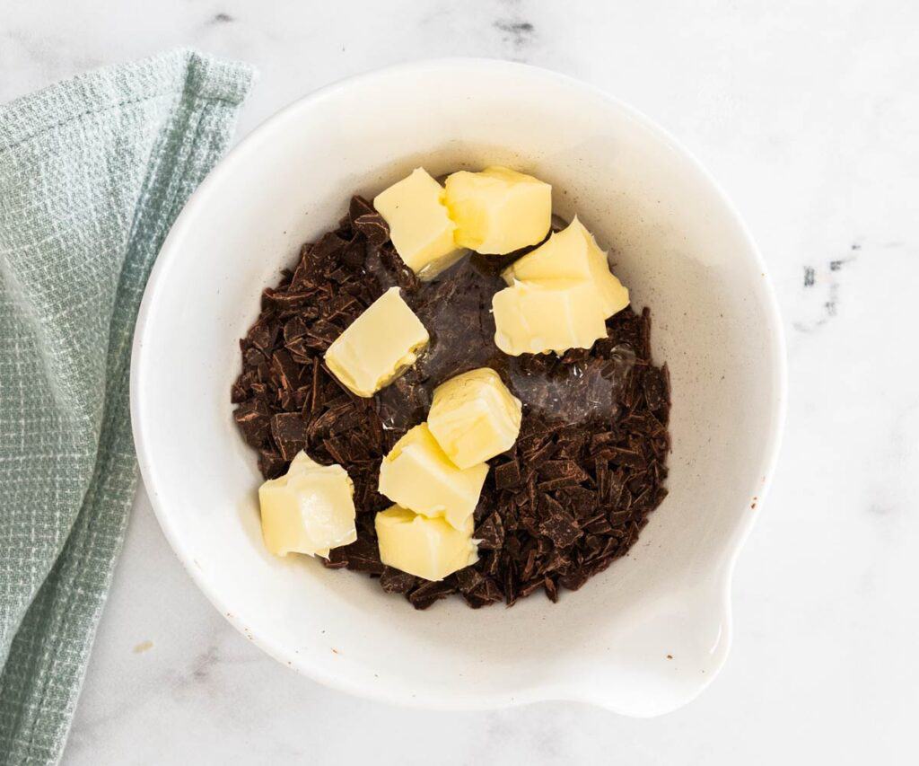 Ingredients for chocolate glaze in a bowl.