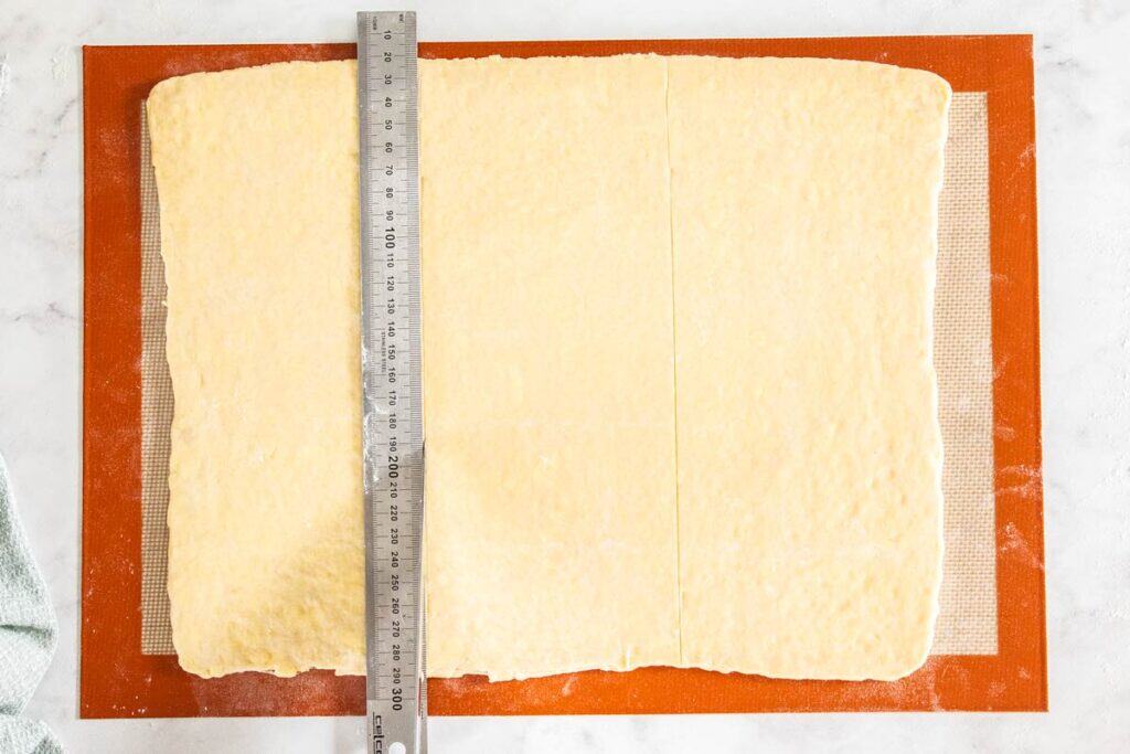 A ruler on top of the pastry showing the scored lines.