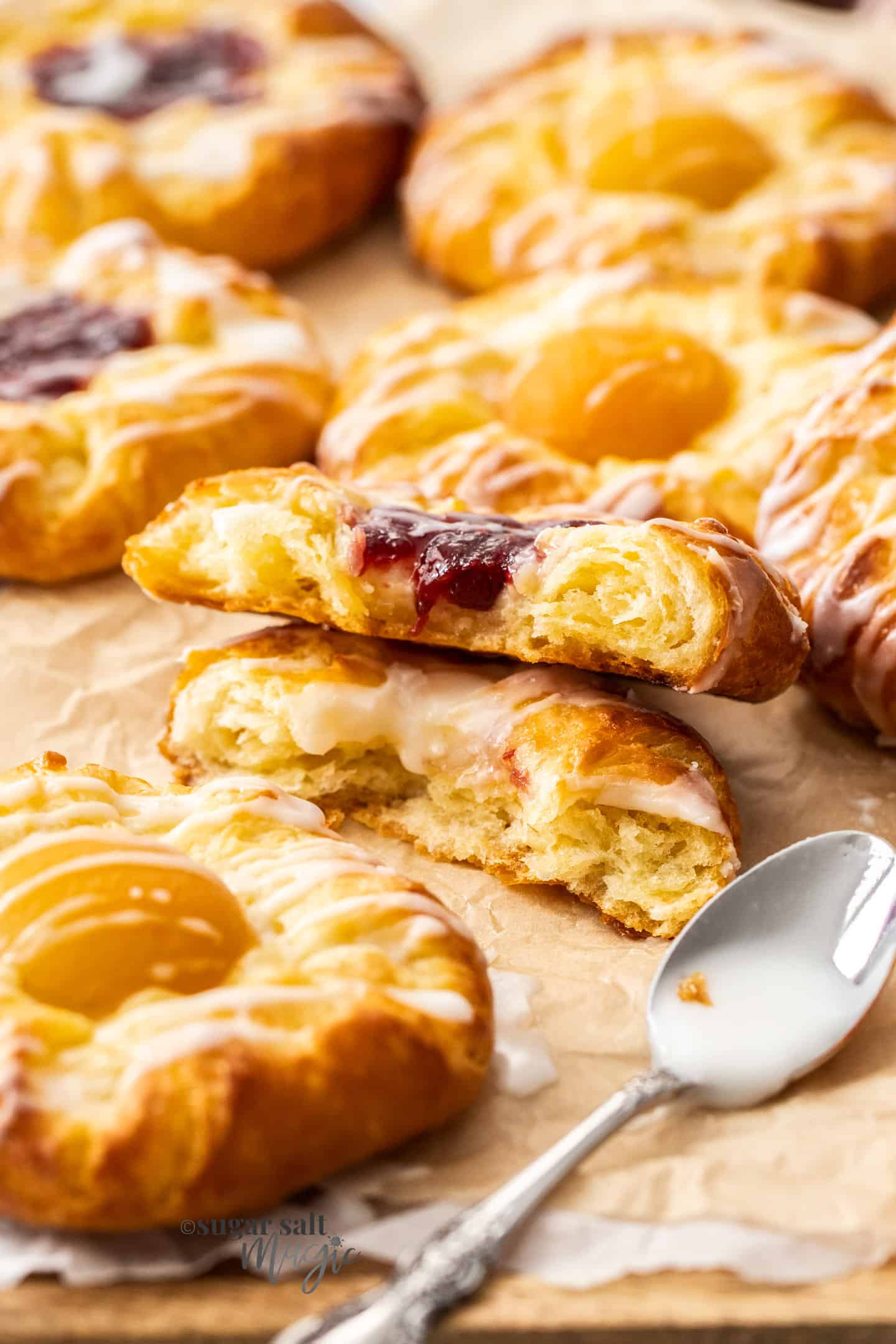 Two stack Danish pastries broken in half to show the texture inside.