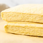 Two blocks of Danish pastry dough stacked showing the layers inside.