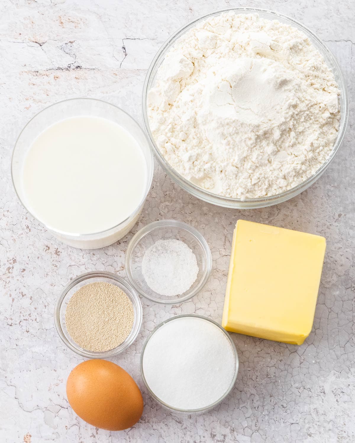 Ingredients for Danish pastry on a stone surface.