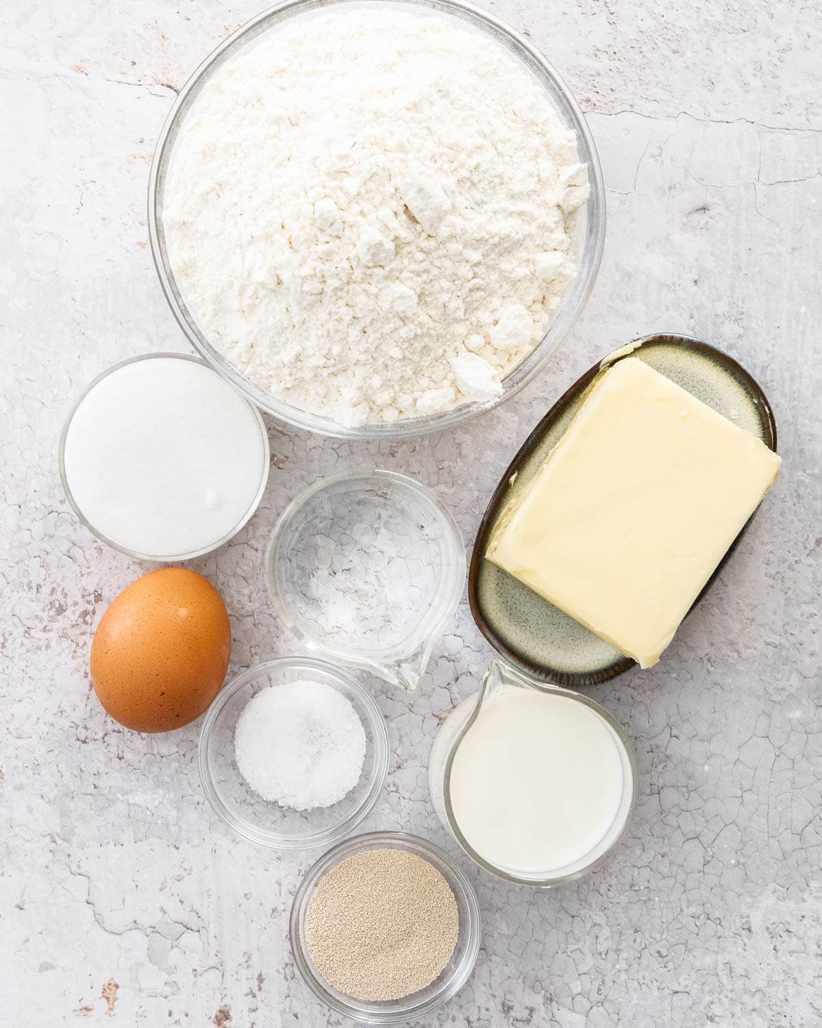 Ingredients for croissants on a stone surface.