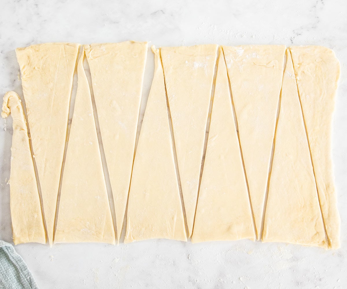 The dough all cut into triangles.