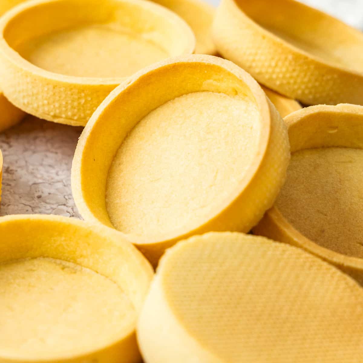 Closeup of a pâte sablée tart shell on an angle.