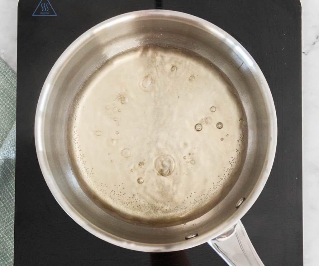 The syrup simmering in a pan.