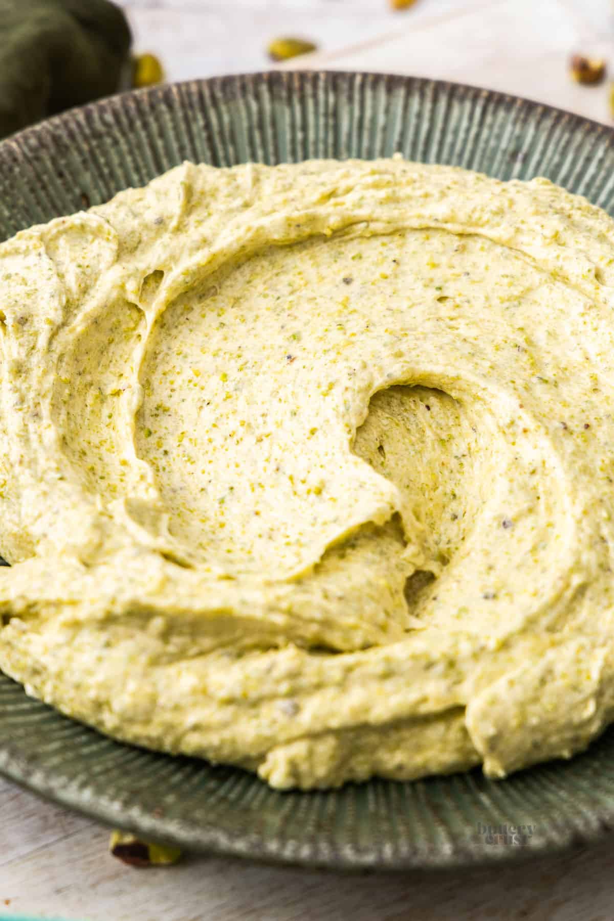 Closeup of pistachio frangipane filling on a plate.