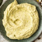 Top down view of pistachio frangipane filling swirled on a plate.