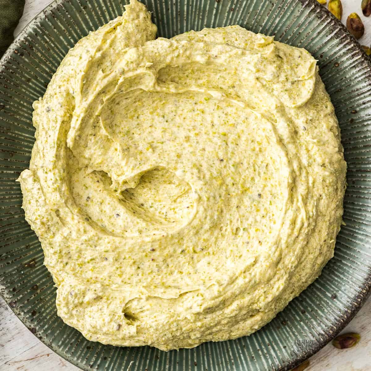 Top down view of pistachio frangipane filling swirled on a plate.