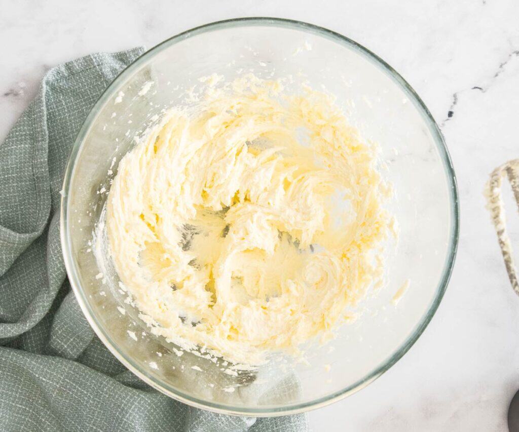 Butter and sugar beaten together in a bowl.