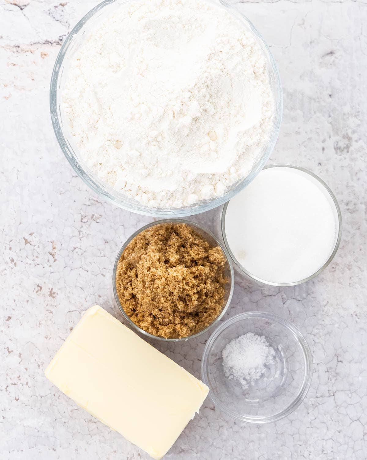 Ingredients for streusel crumble topping on a stone surface.