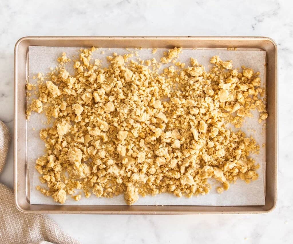 The streusel topping on a baking sheet ready to bake.
