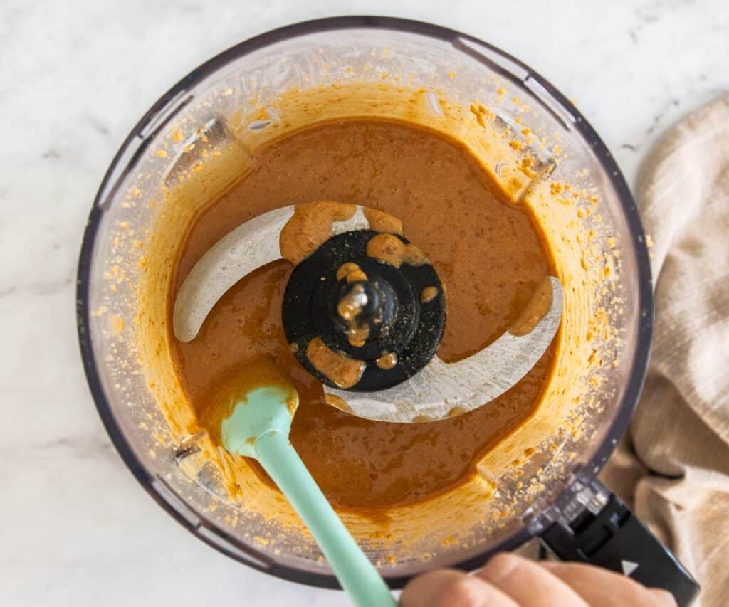 The smooth fluid praline paste in a food processor.