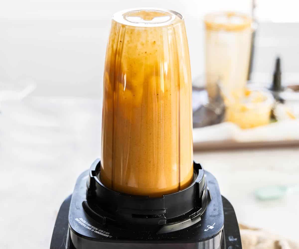 A blender blending hazelnut praline paste.