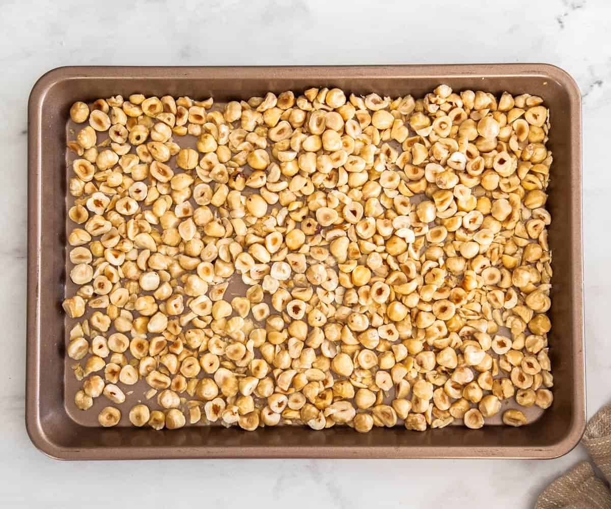 Hazelnuts on a baking tray.