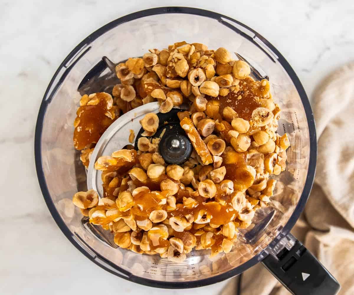 The caramel and hazelnuts in a food processor.
