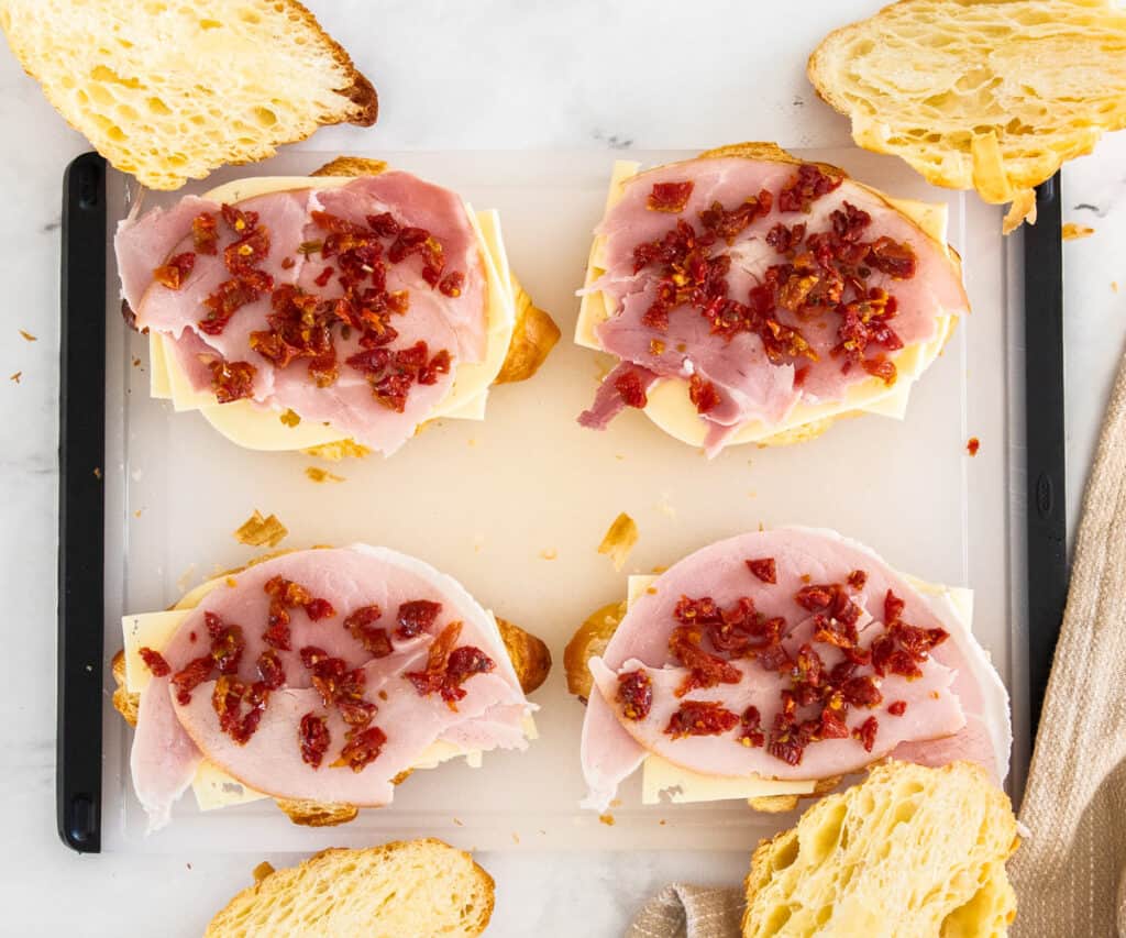 Croissant bases topped with cheese ham and sun dried tomatoes.