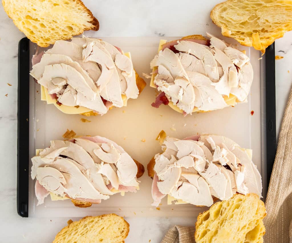 Turkey added on top of the ham and tomatoes.