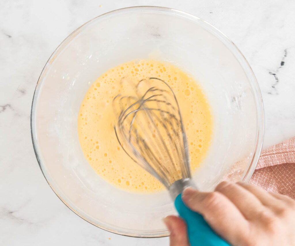 Eggs and cornstarch being whisked together.