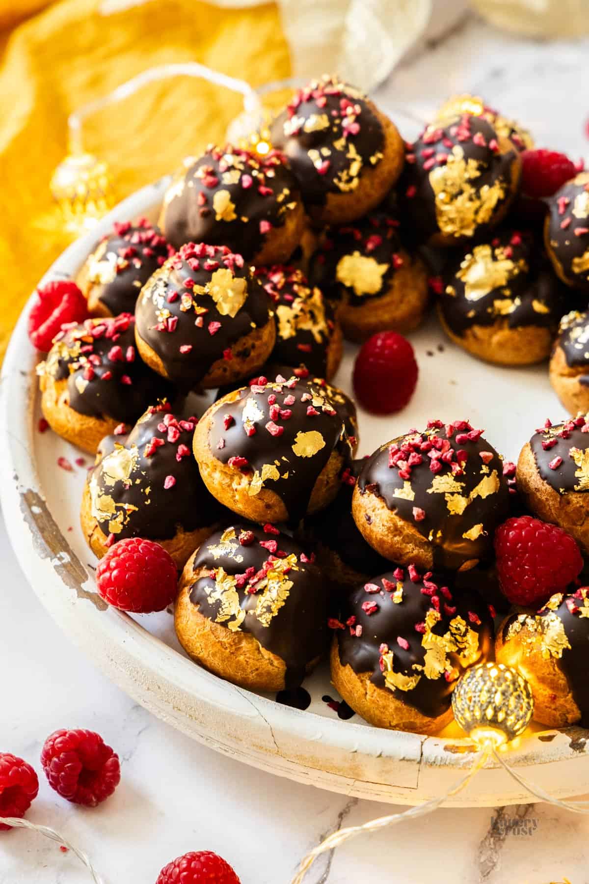 Closeup of one side of the raspberry profiterole wreath.