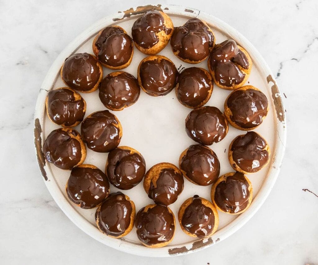 One ring of raspberry profiteroles on a serving platter.
