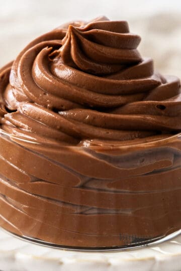 A big swirl of chocolate pastry cream in a glass dish.