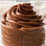 A glass dish filled with a big swirl of chocolate pastry cream.