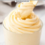 A spoon lifting creme legere from a glass.