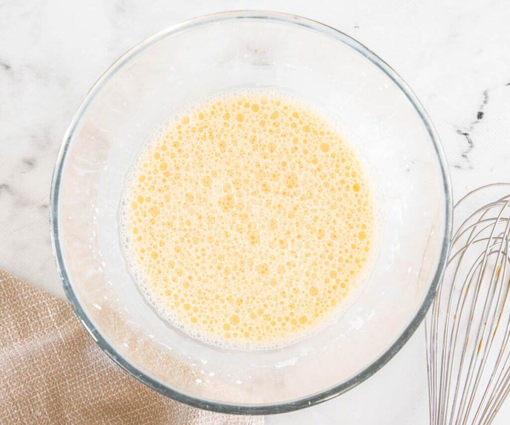 The eggs and cornflour whisked in a bowl.