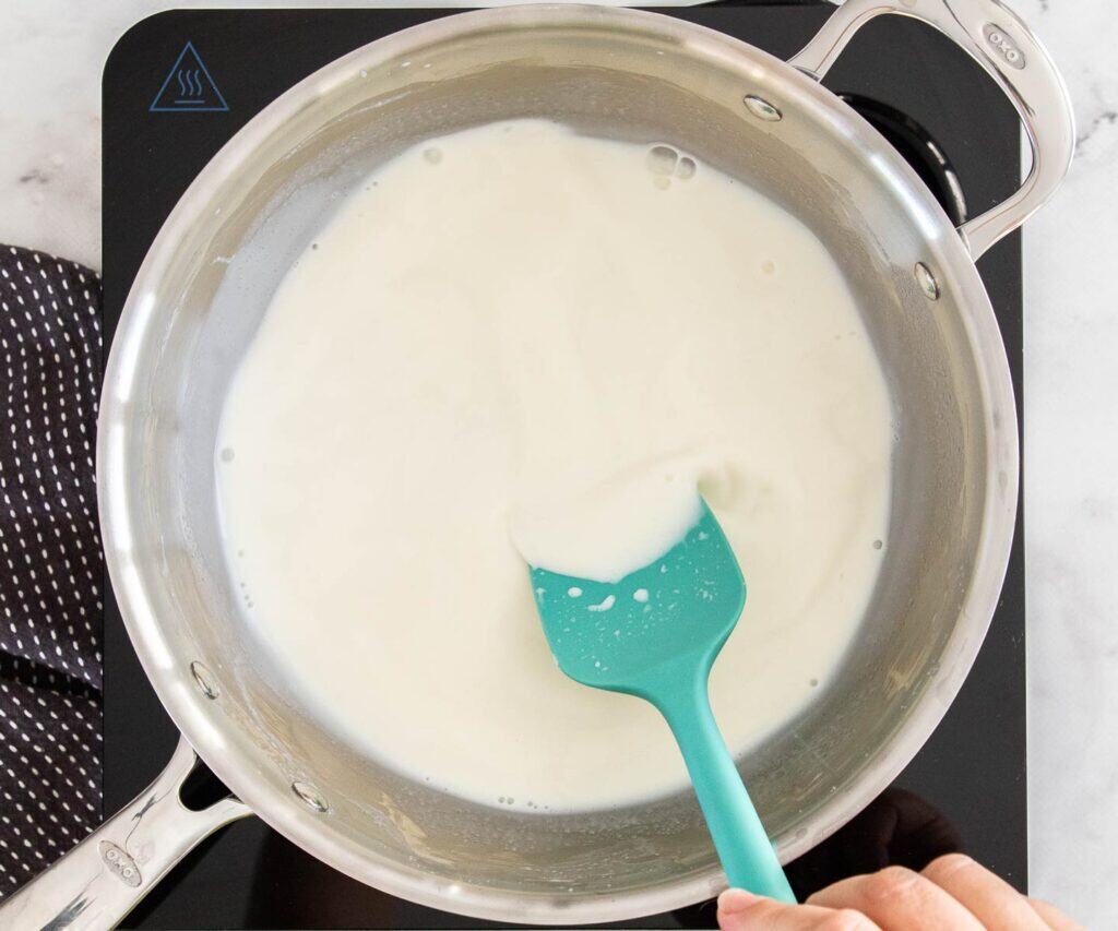 Heating the milk in a saucepan.
