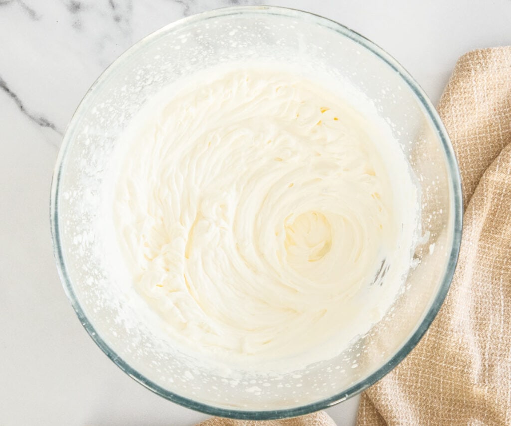 The cream whipped in a mixing bowl.