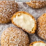 Top down view of a choux a la creme that's been cut in half to show the filling inside.