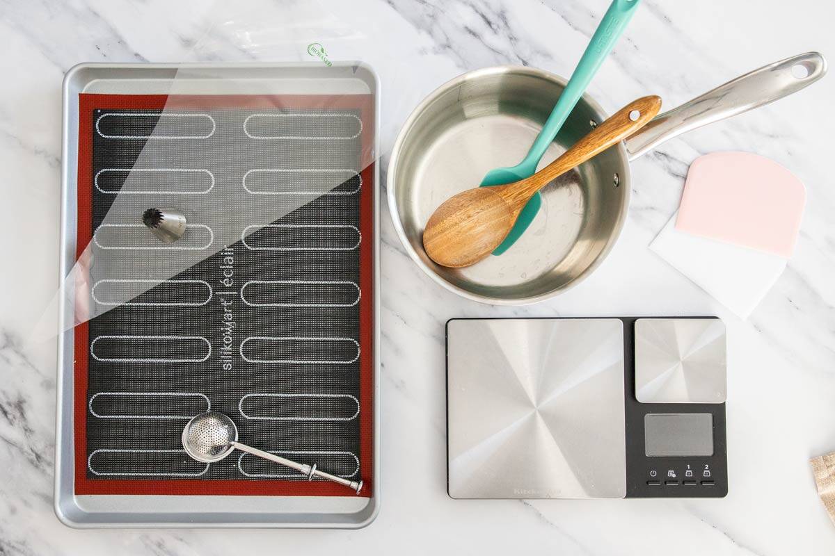 Equipment for making eclairs on a marble background.