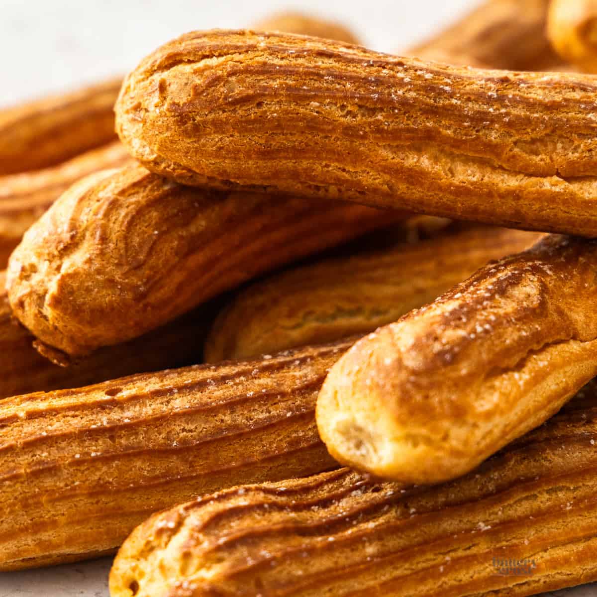 Closeup of a pile of eclairs.