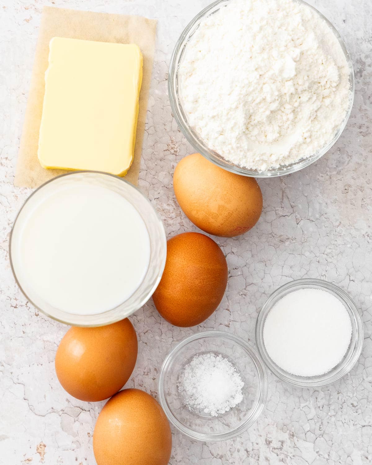 Ingredients for making eclair shells on a concrete bench.