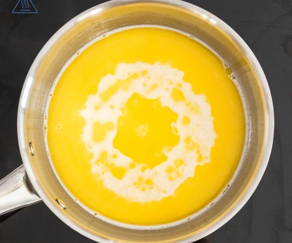 The butter and milk bubbling in a pan for eclair pastry.