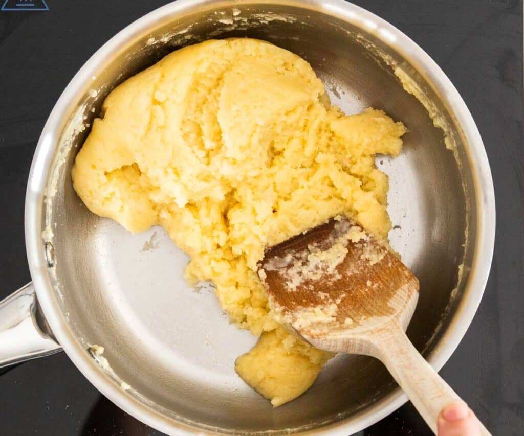 The flour mixed into the butter and milk in a saucepan.