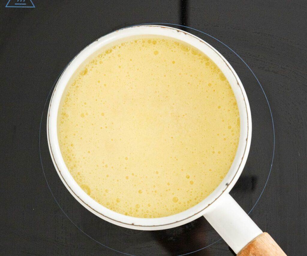 Butter foaming in a saucepan.