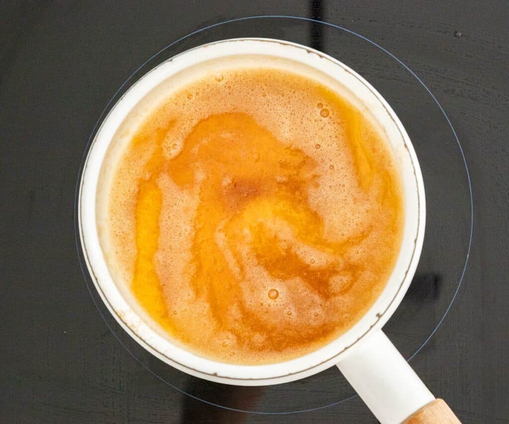The browned butter in a saucepan.