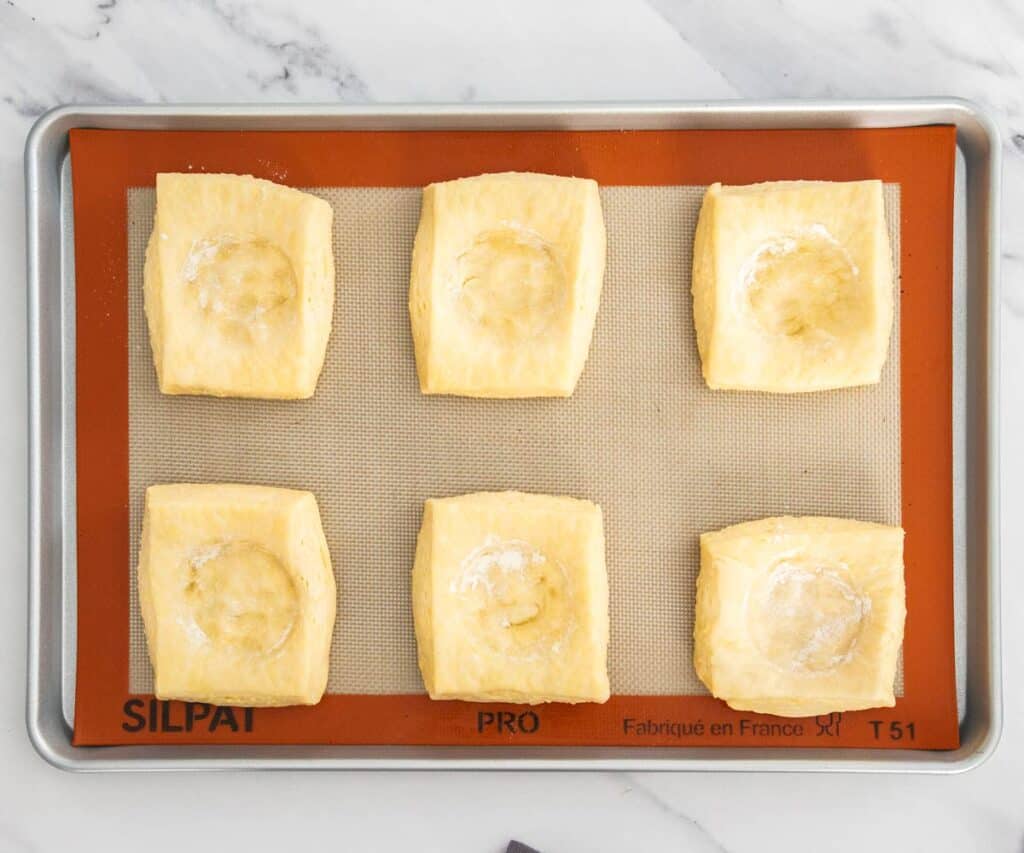 Square danish pastries with a dent pressed into the centre.
