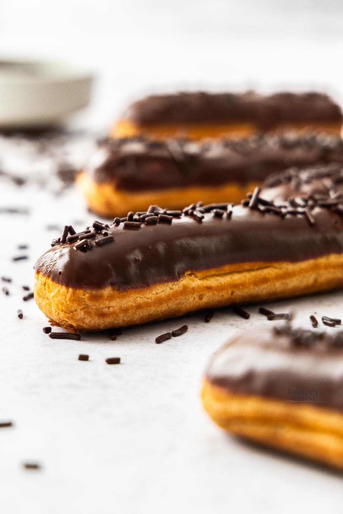 Closeup of one end of a chocolate eclair.