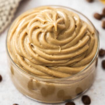 Extreme closeup of coffee pastry cream in a glass dish.