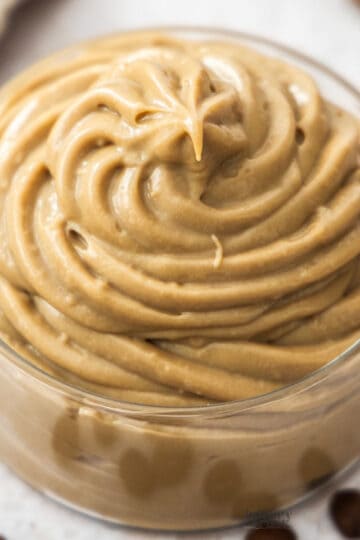 Extreme closeup of coffee pastry cream in a glass dish.