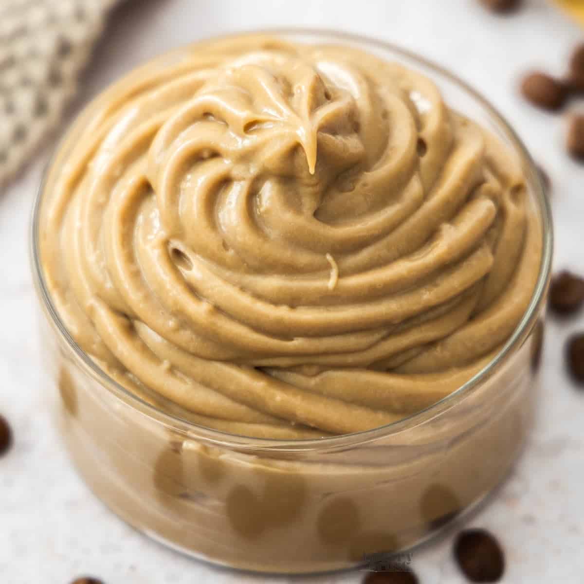 Extreme closeup of coffee pastry cream in a glass dish.