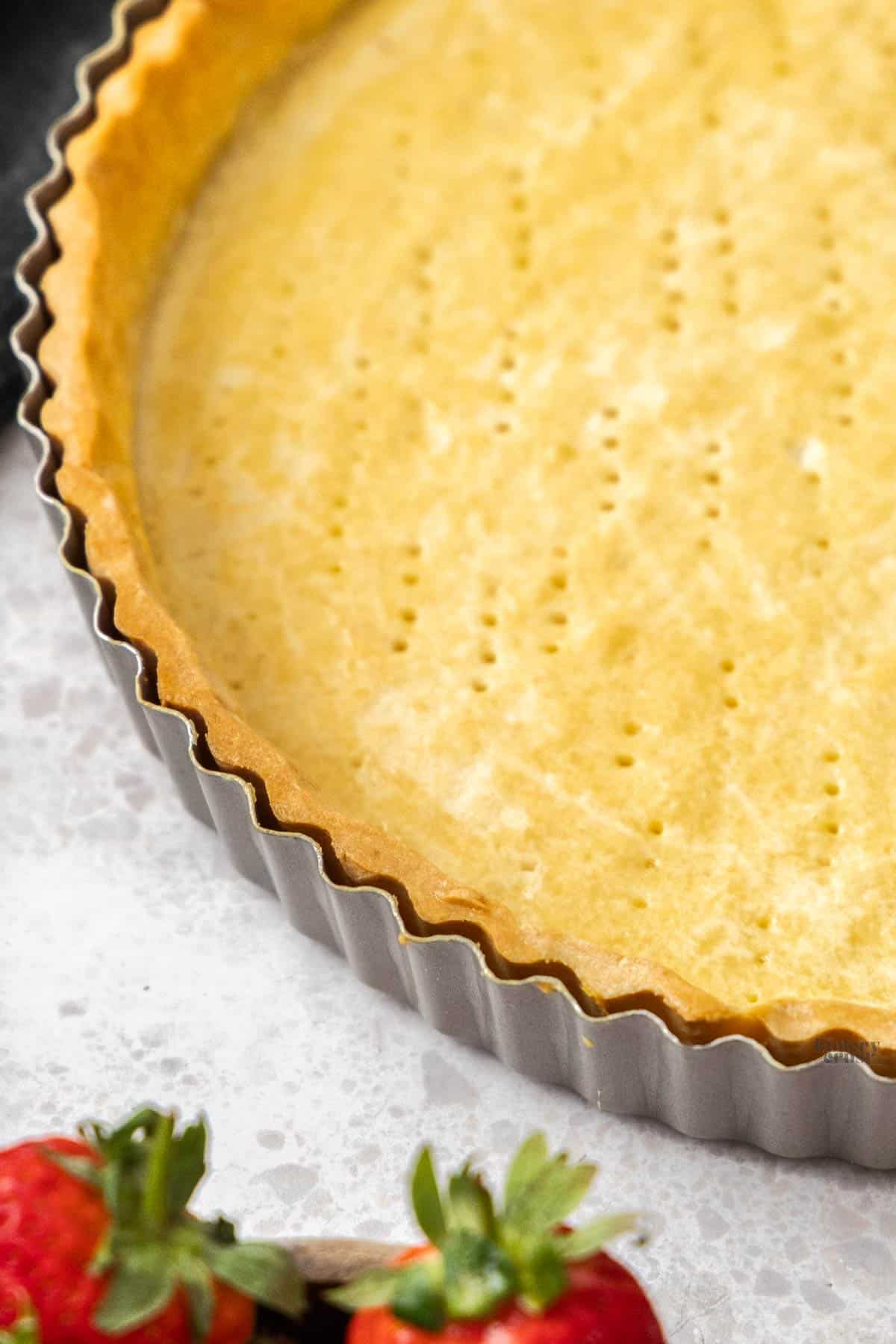 Extreme closeup of the golden brown edge of the tart shell.