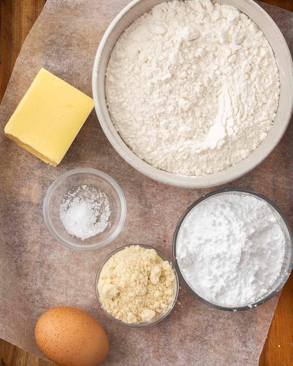 Ingredients for Pâte Sucrée on a wooden board.